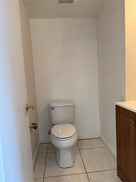 8031 Lagos De Campo Boulevard, Unit L3 Tamarac, FL 33321 - Photo 14 of 26 a white toilet sitting next to a white wall