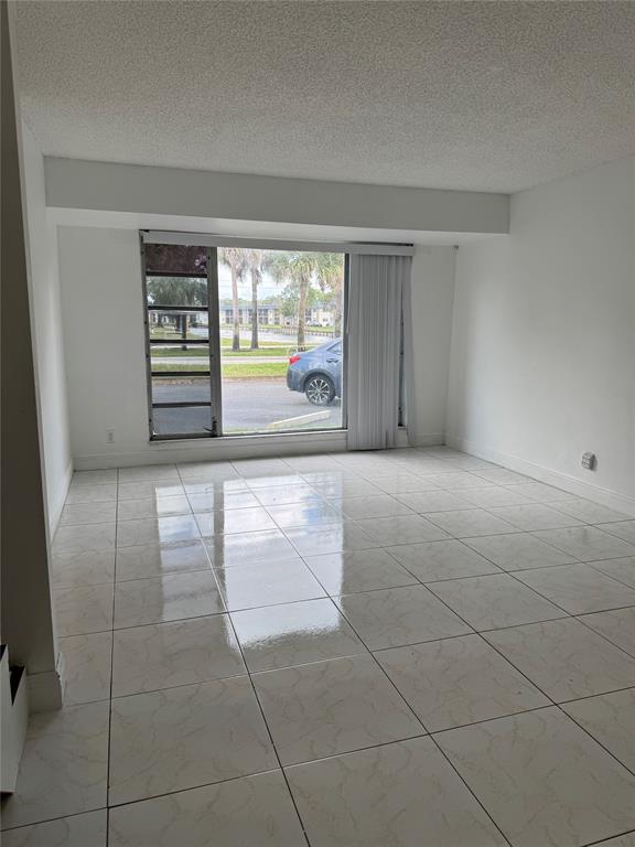 8031 Lagos De Campo Boulevard, Unit L3 Tamarac, FL 33321 - Photo 15 of 26 a view of an empty room with a window