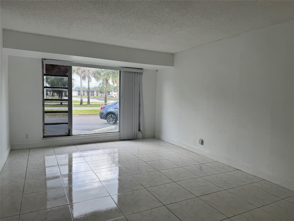 8031 Lagos De Campo Boulevard, Unit L3 Tamarac, FL 33321 - Photo 17 of 26 an empty room with windows