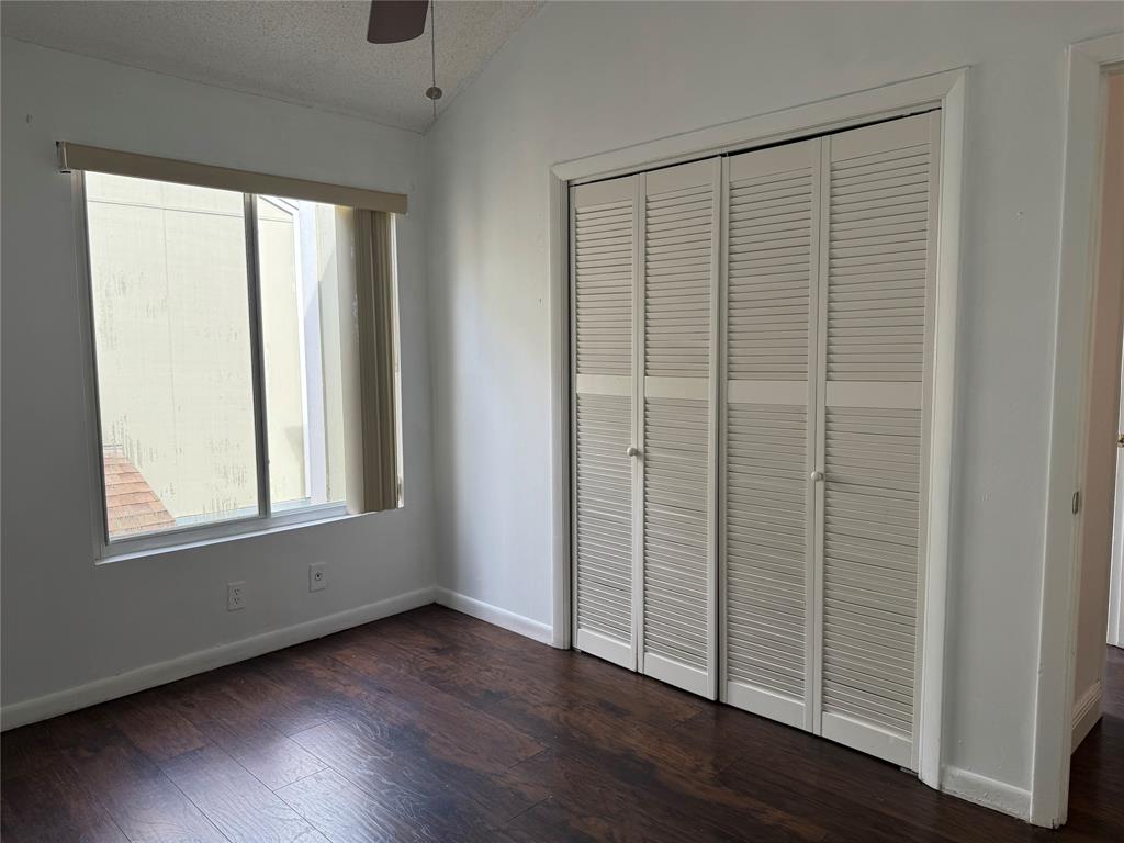 8031 Lagos De Campo Boulevard, Unit L3 Tamarac, FL 33321 - Photo 19 of 26 an empty room with wooden floor and windows