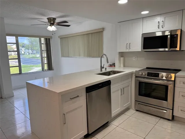 a kitchen with a sink cabinets and microwave