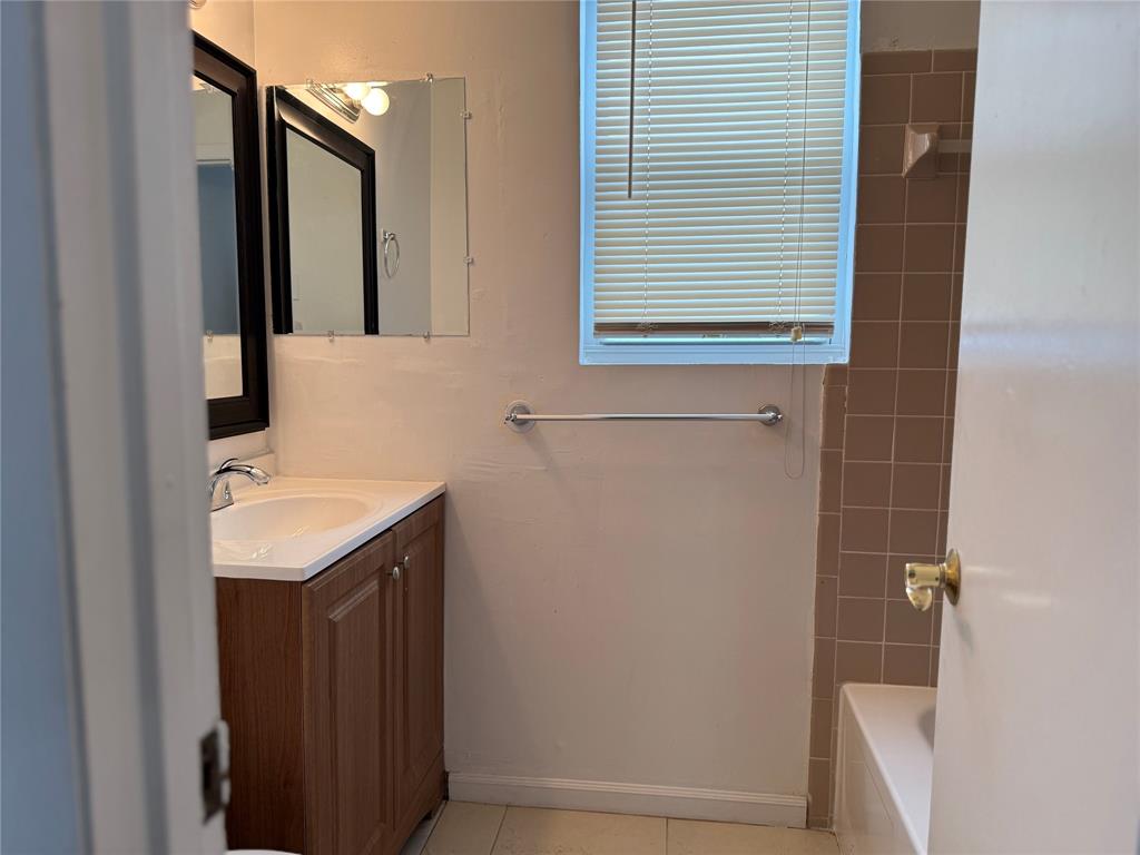 8031 Lagos De Campo Boulevard, Unit L3 Tamarac, FL 33321 - Photo 23 of 26 a bathroom with a sink and a mirror