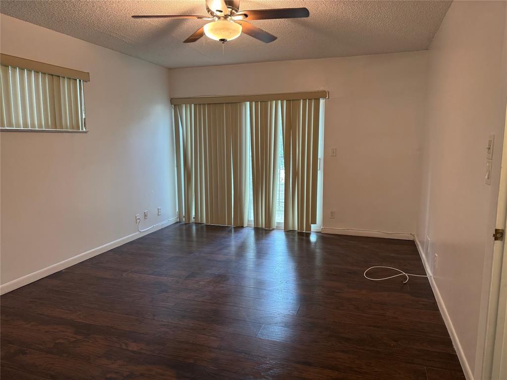 8031 Lagos De Campo Boulevard, Unit L3 Tamarac, FL 33321 - Photo 24 of 26 an empty room with wooden floor and windows