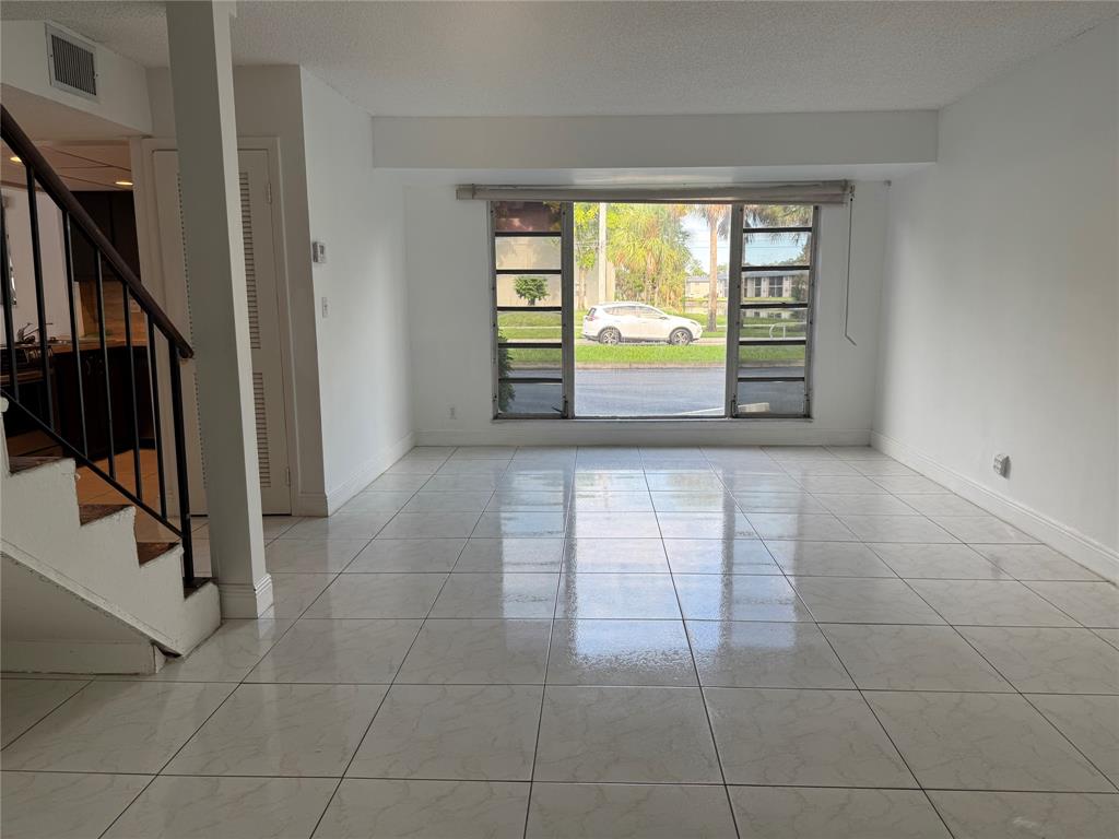 8031 Lagos De Campo Boulevard, Unit L3 Tamarac, FL 33321 - Photo 5 of 26 a view of an empty room with a window