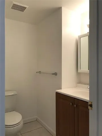 a bathroom with a sink toilet and vanity