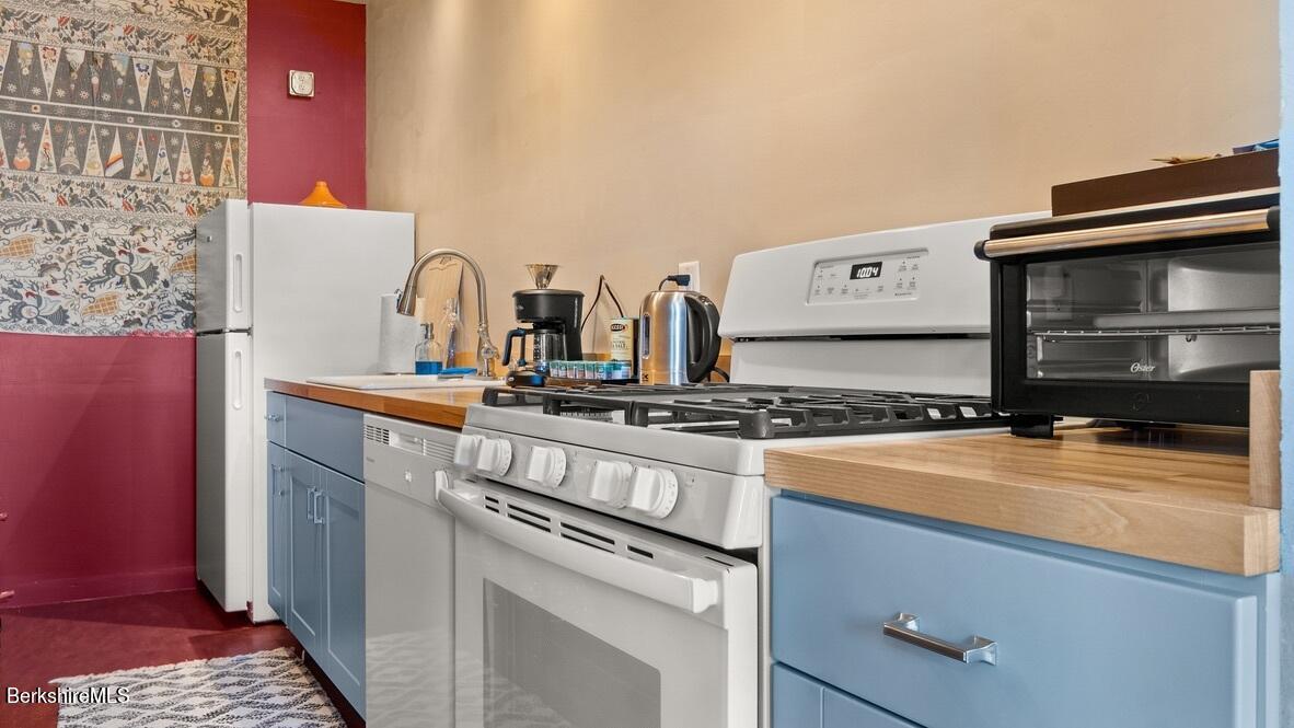 264 Main Street, Unit B Great Barrington, MA 01230 - Photo 17 of 26 a kitchen with a stove and a microwave