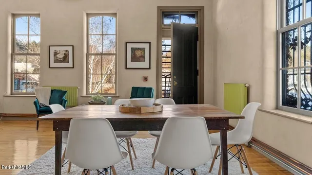 a view of a dining room with furniture and a potted plant