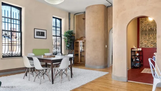 a view of a dining room with furniture and wooden floor