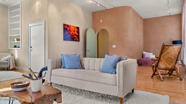 a living room with furniture and wooden floor