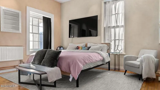 a bedroom with a bed and a flat screen tv