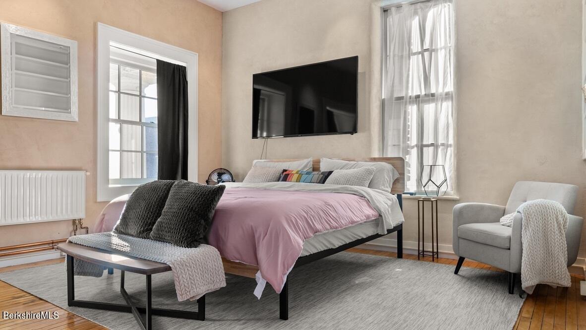 264 Main Street, Unit B Great Barrington, MA 01230 - Photo 8 of 26 a bedroom with a bed and a flat screen tv