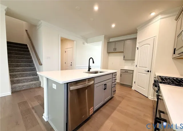 a kitchen with a sink stove and cabinets