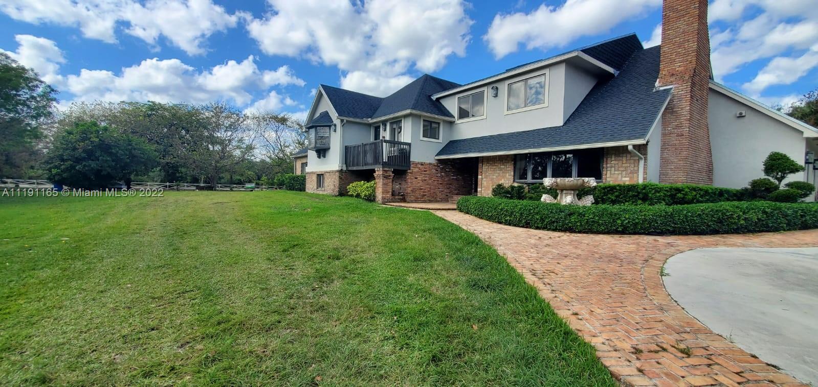 7111 Holatee Trail Southwest Ranches, FL 33330 - Photo 1 of 13 a front view of a house with a yard