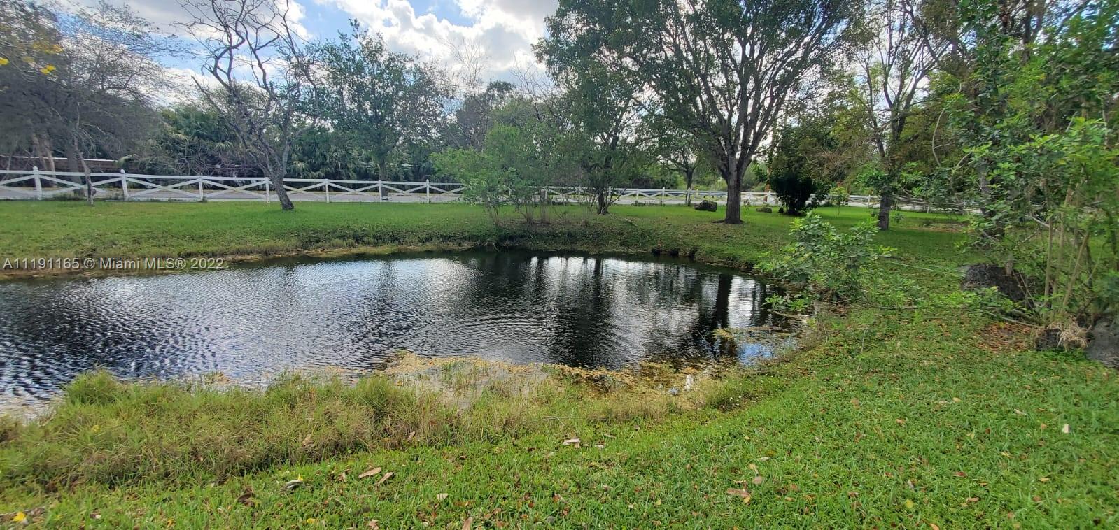 7111 Holatee Trail Southwest Ranches, FL 33330 - Photo 5 of 13 a view of a lake with houses in background