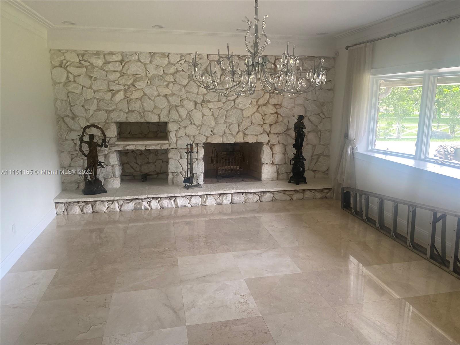 7111 Holatee Trail Southwest Ranches, FL 33330 - Photo 8 of 13 a view of a livingroom with a fireplace and window