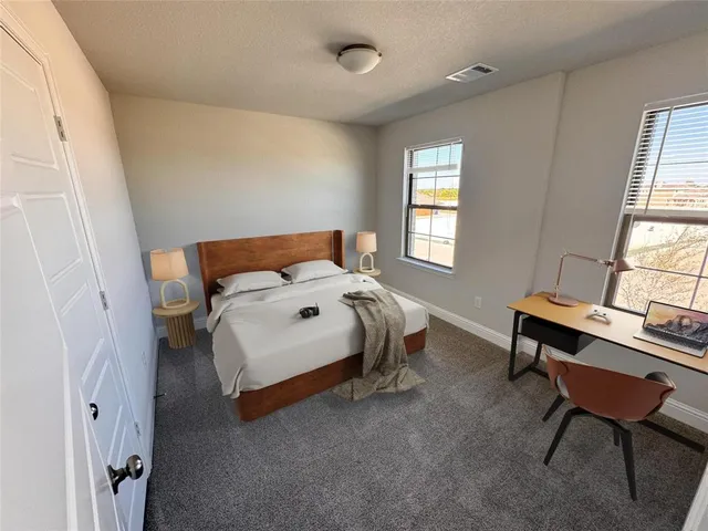 a bedroom with furniture and a window