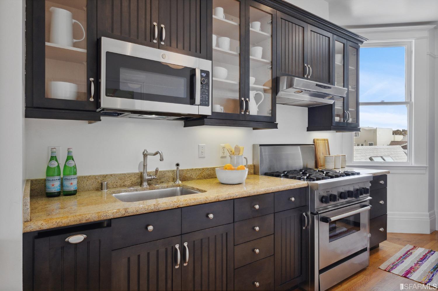394 Elizabeth Street San Francisco, CA 94114 - Photo 12 of 33 a kitchen with stainless steel appliances granite countertop a sink stove and microwave