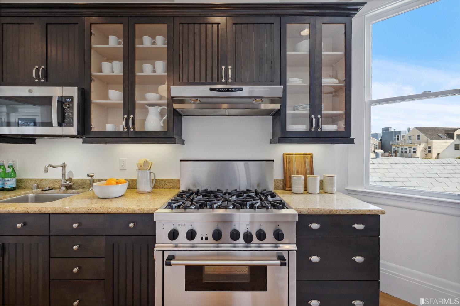 394 Elizabeth Street San Francisco, CA 94114 - Photo 13 of 33 a kitchen with stainless steel appliances granite countertop a stove and a sink