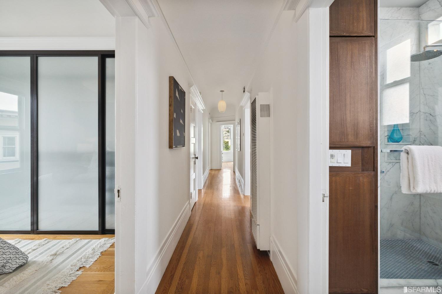 394 Elizabeth Street San Francisco, CA 94114 - Photo 25 of 33 a view of a hallway with wooden floor and staircase