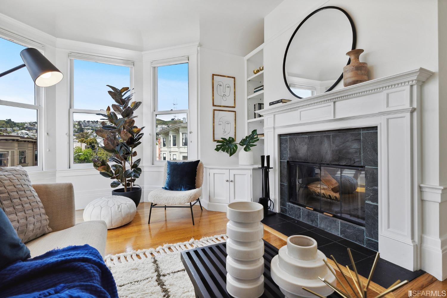 394 Elizabeth Street San Francisco, CA 94114 - Photo 3 of 33 a living room with furniture a fireplace and potted plants