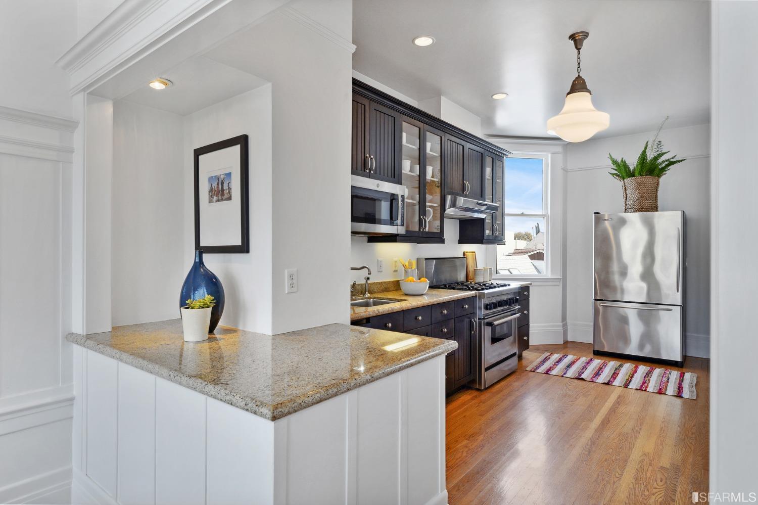 394 Elizabeth Street San Francisco, CA 94114 - Photo 10 of 33 a kitchen with stainless steel appliances granite countertop a refrigerator a stove and a sink