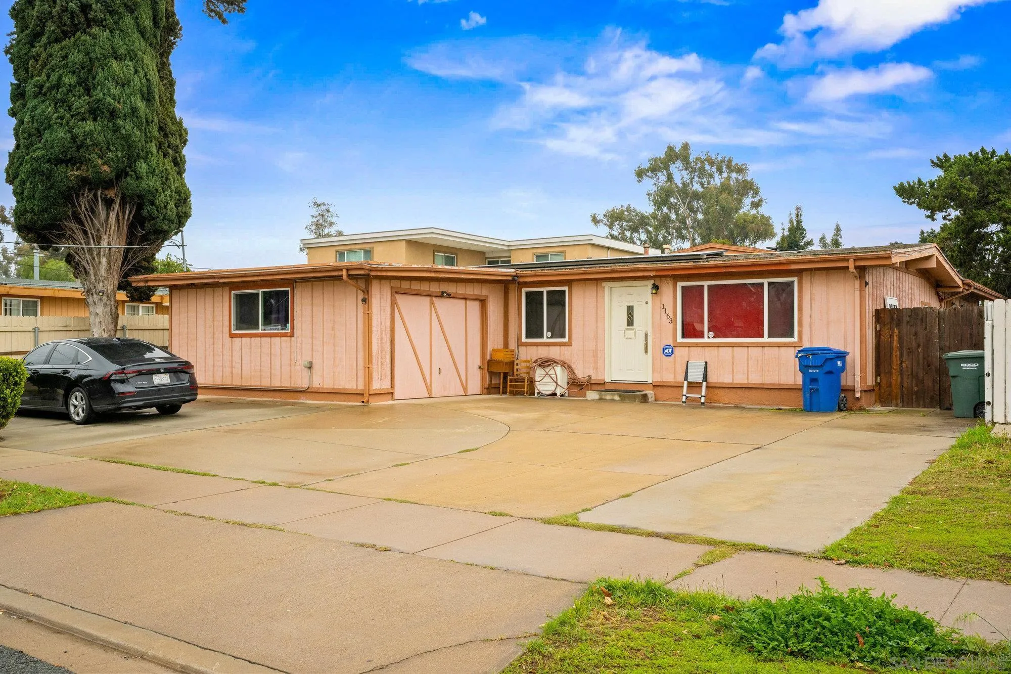 1163 Naranca Avenue El Cajon, CA 92021 - Photo 2 of 15 a front view of a house with a yard and garage