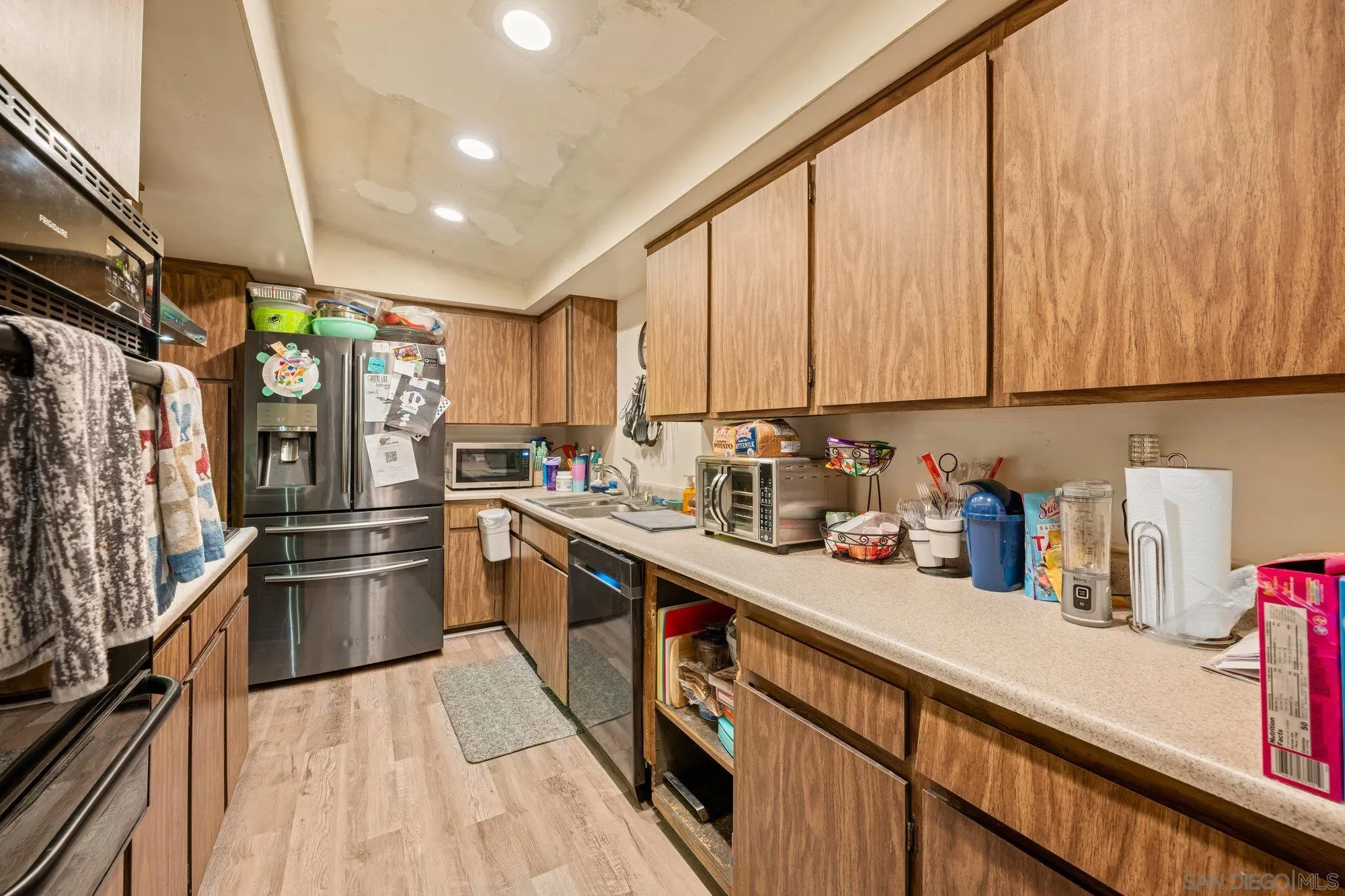 1163 Naranca Avenue El Cajon, CA 92021 - Photo 4 of 15 a kitchen with stainless steel appliances a refrigerator sink and cabinets