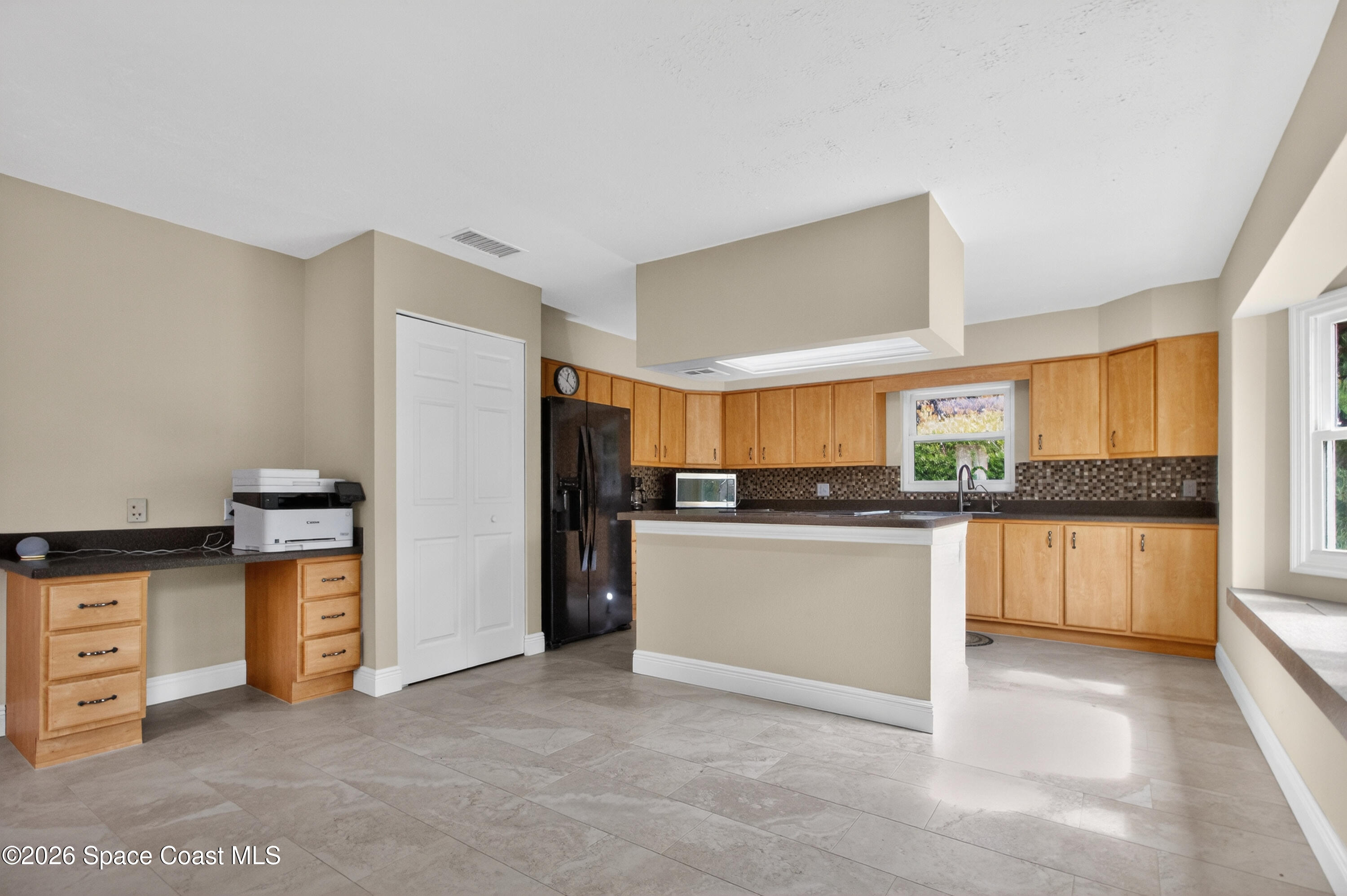 270 Mockingbird Lane Merritt Island, FL 32953 - Photo 16 of 41 a kitchen with stainless steel appliances granite countertop a refrigerator a sink dishwasher a stove with white cabinets