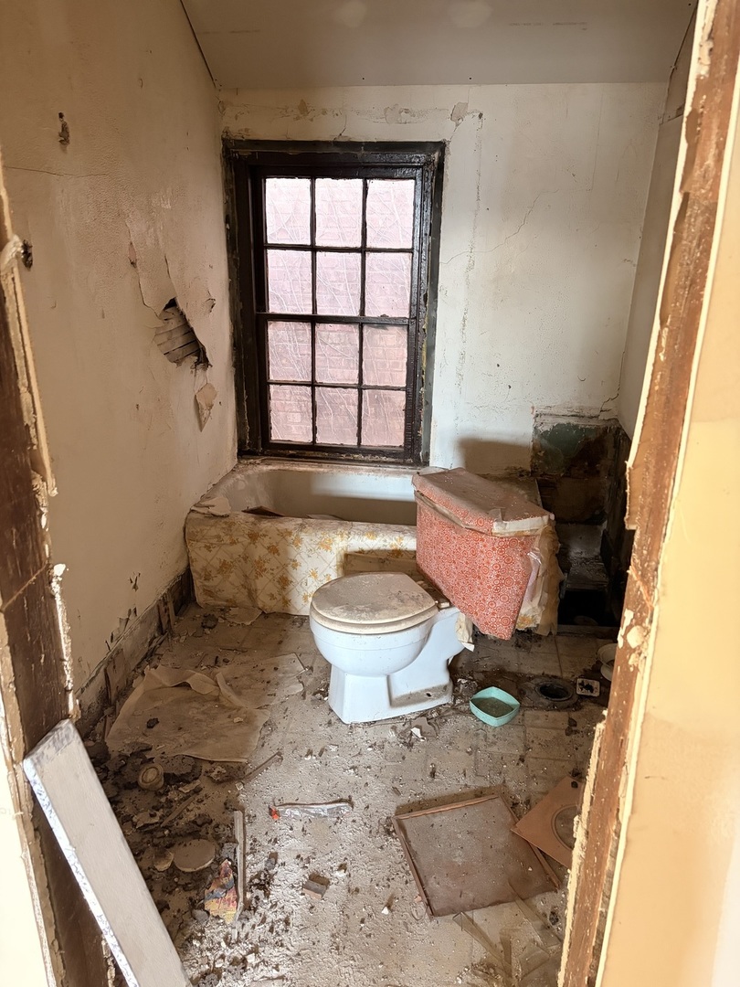 1901 Chicago Road Chicago Heights, IL 60411 - Photo 15 of 20 a bathroom with a sink toilet and window