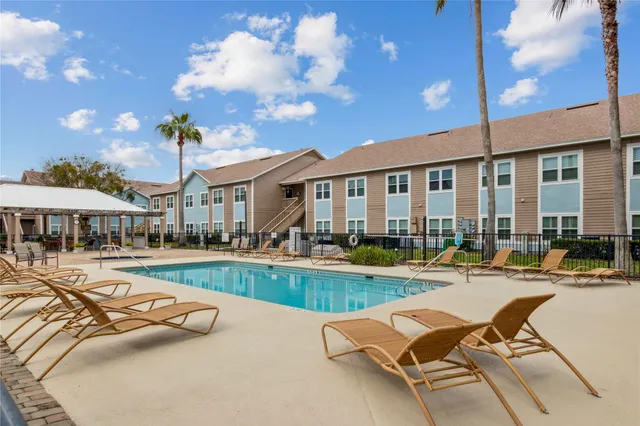 a view of a house with garden and trees