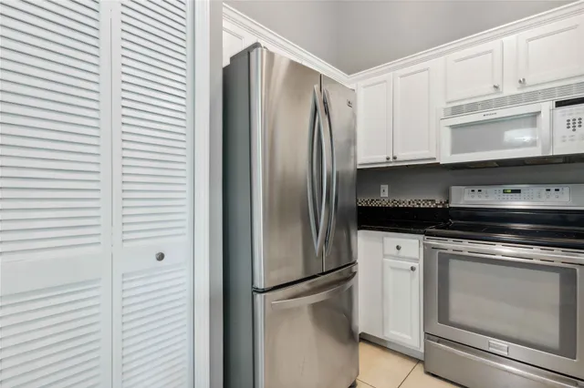 a kitchen with granite countertop a sink and cabinets