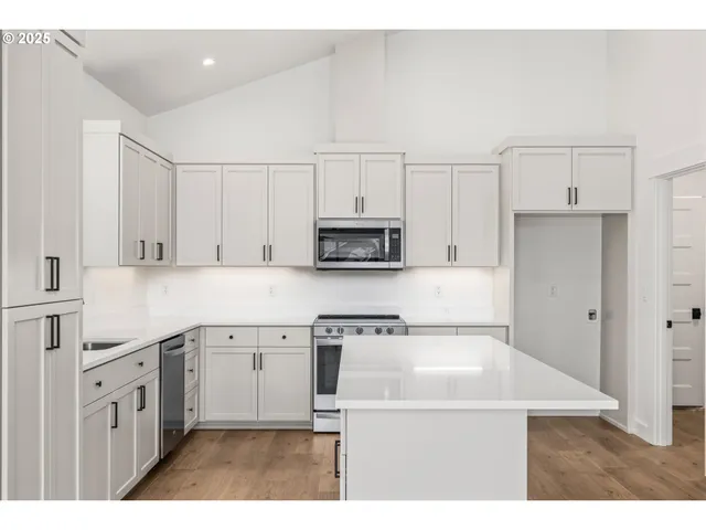 a kitchen with cabinets and white appliances