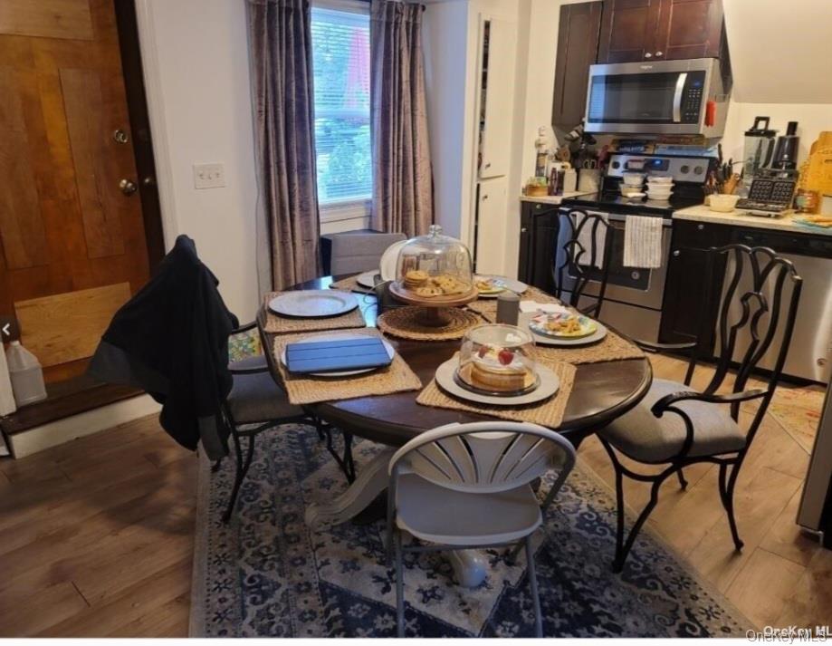 556 Hawkins Road Selden, NY 11784 - Photo 11 of 12 a dining room with furniture a rug and wooden floor