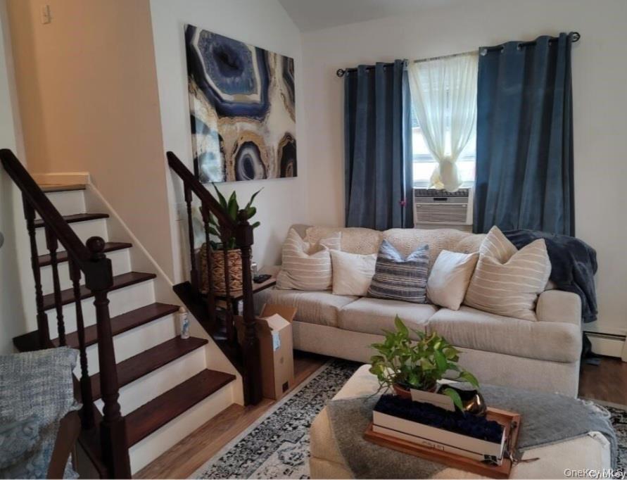 556 Hawkins Road Selden, NY 11784 - Photo 6 of 12 a living room with furniture and a painting on the wall