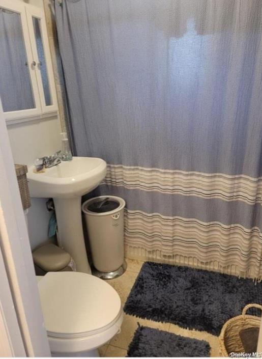 556 Hawkins Road Selden, NY 11784 - Photo 7 of 12 a bathroom with a toilet and a sink