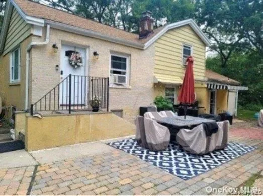 a view of a house with backyard and sitting area