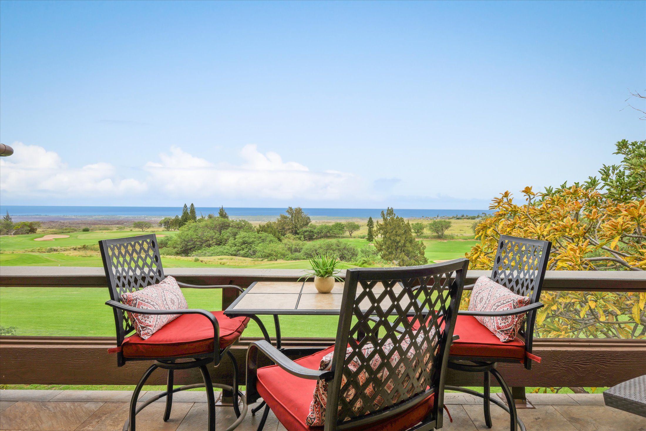 an outdoor sitting area with furniture and garden view
