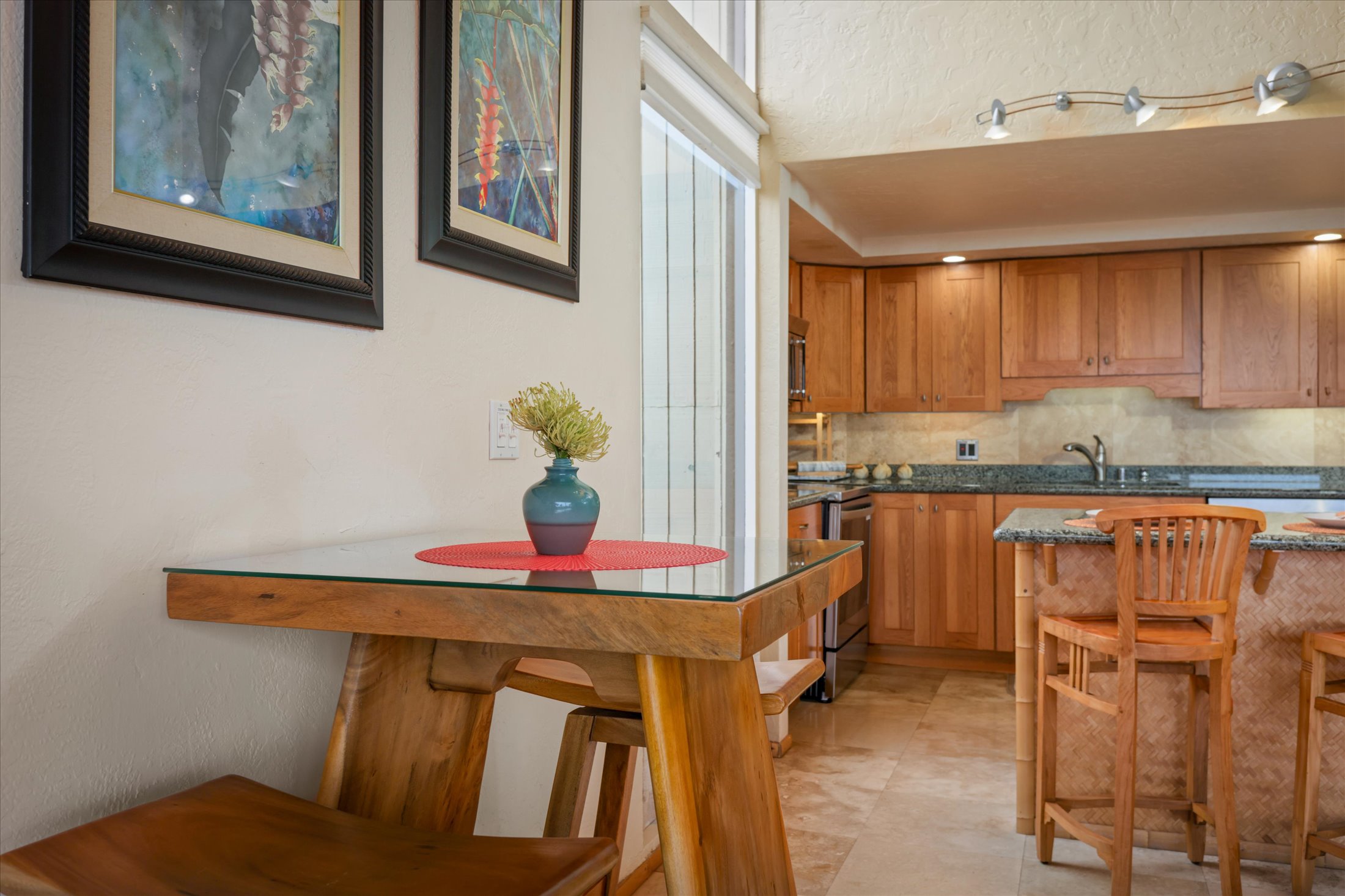 68-1771 Melia Street, Unit G214 Waikoloa, HI 96738 - Photo 11 of 29 a kitchen with granite countertop cabinets and chair