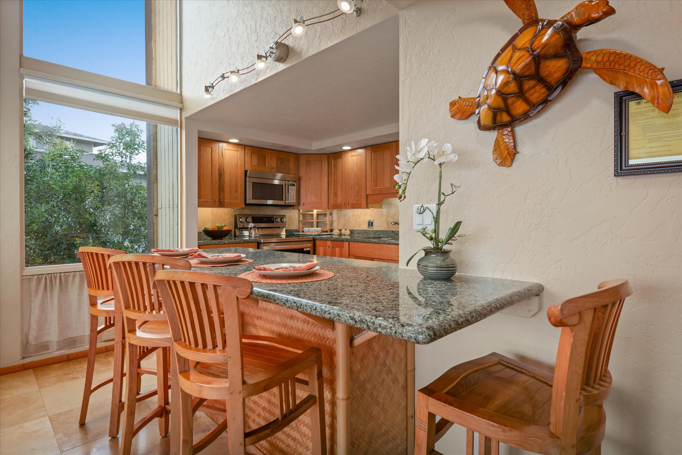 68-1771 Melia Street, Unit G214 Waikoloa, HI 96738 - Photo 13 of 29 a kitchen with a table chairs and a wooden floor