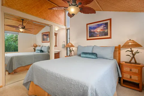 a bedroom with a bed a couch and dresser