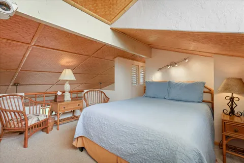 a bed room with a bed and a chair