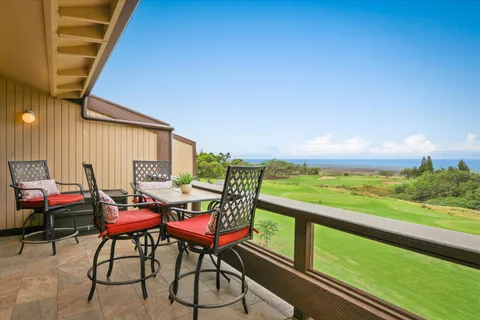 a view of a chairs and table in patio with wooden fence