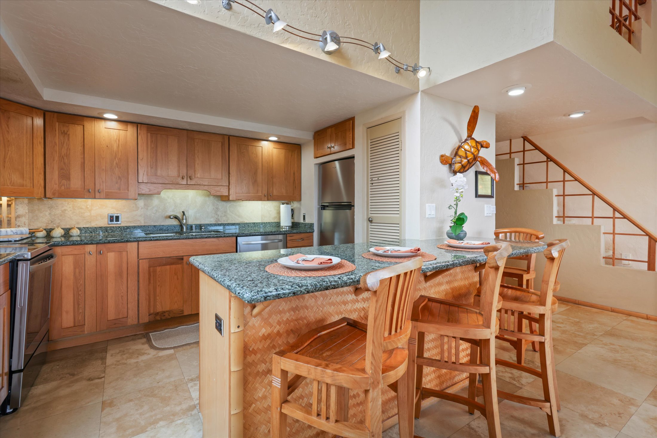 68-1771 Melia Street, Unit G214 Waikoloa, HI 96738 - Photo 3 of 29 a kitchen with stainless steel appliances granite countertop a table chairs sink and cabinets