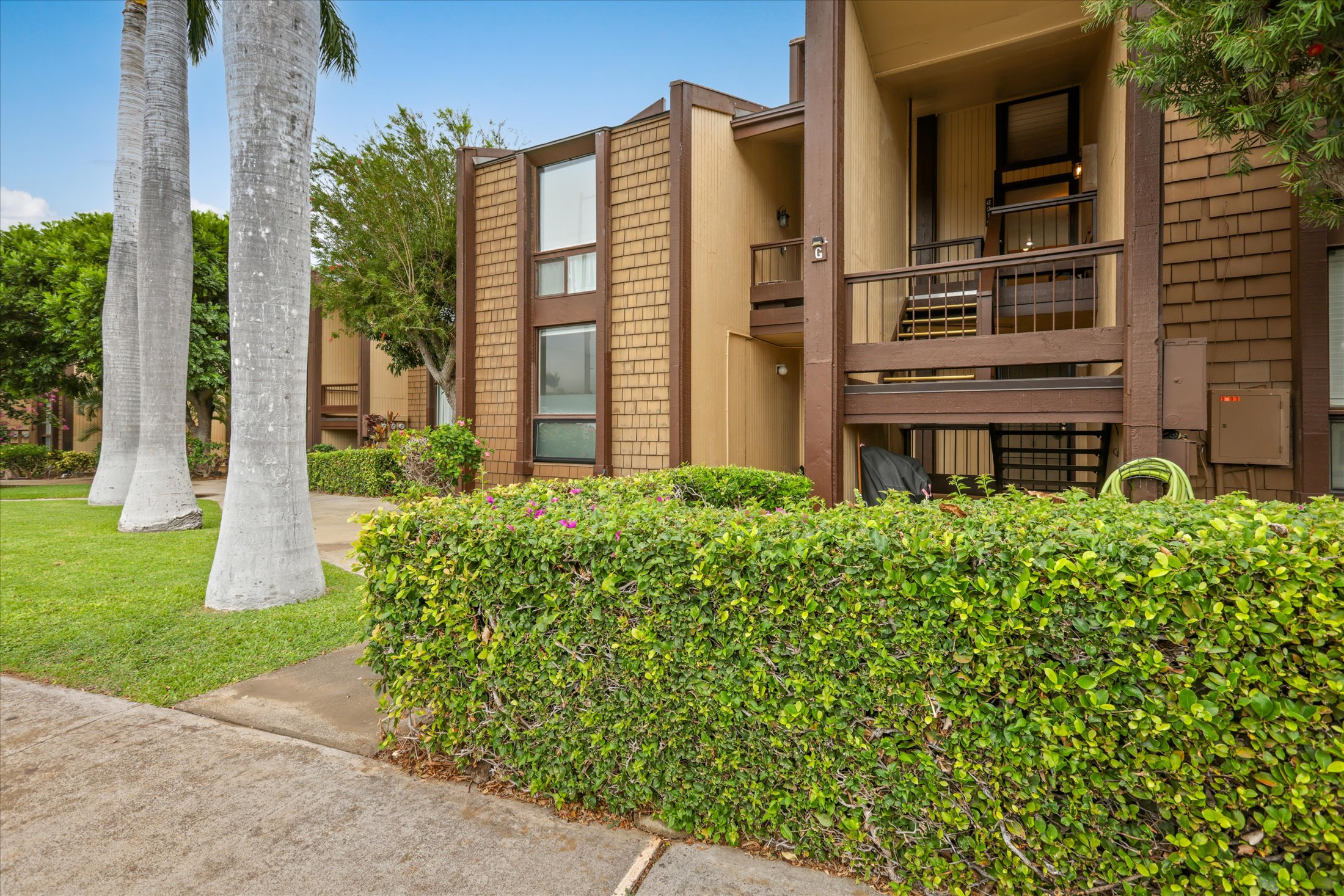 68-1771 Melia Street, Unit G214 Waikoloa, HI 96738 - Photo 4 of 29 front view of a building with a garden