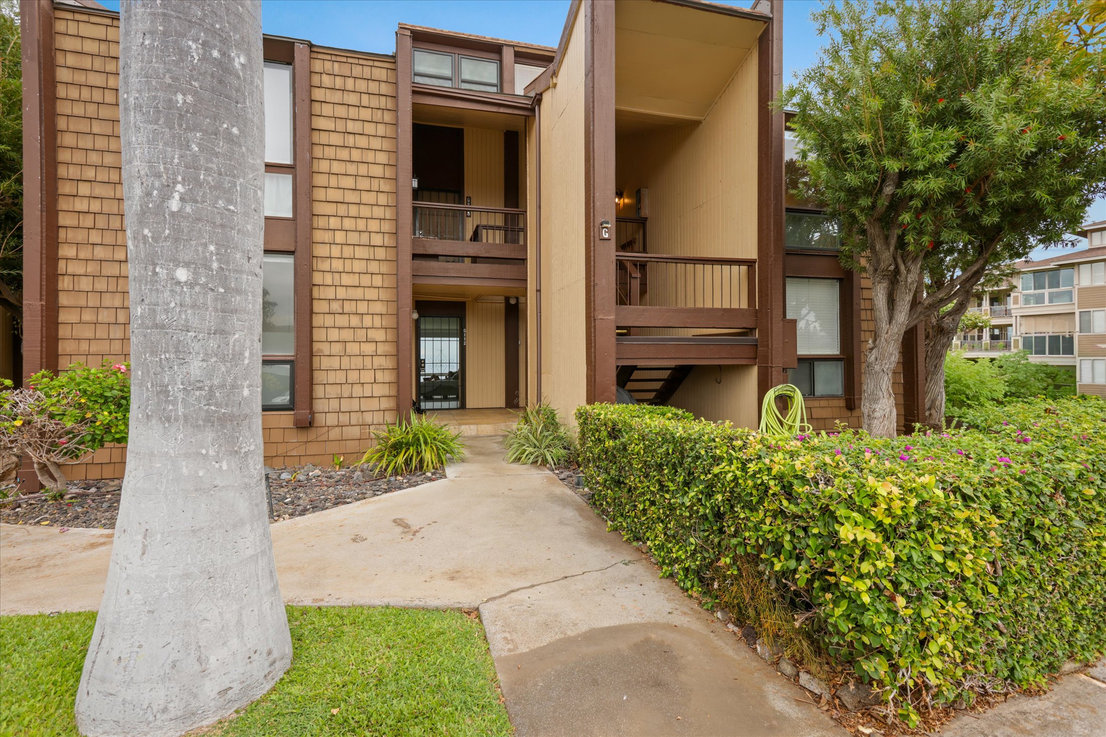68-1771 Melia Street, Unit G214 Waikoloa, HI 96738 - Photo 5 of 29 a front view of a house with garden