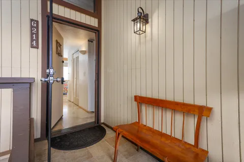 a view of a hallway with a door and a mirror