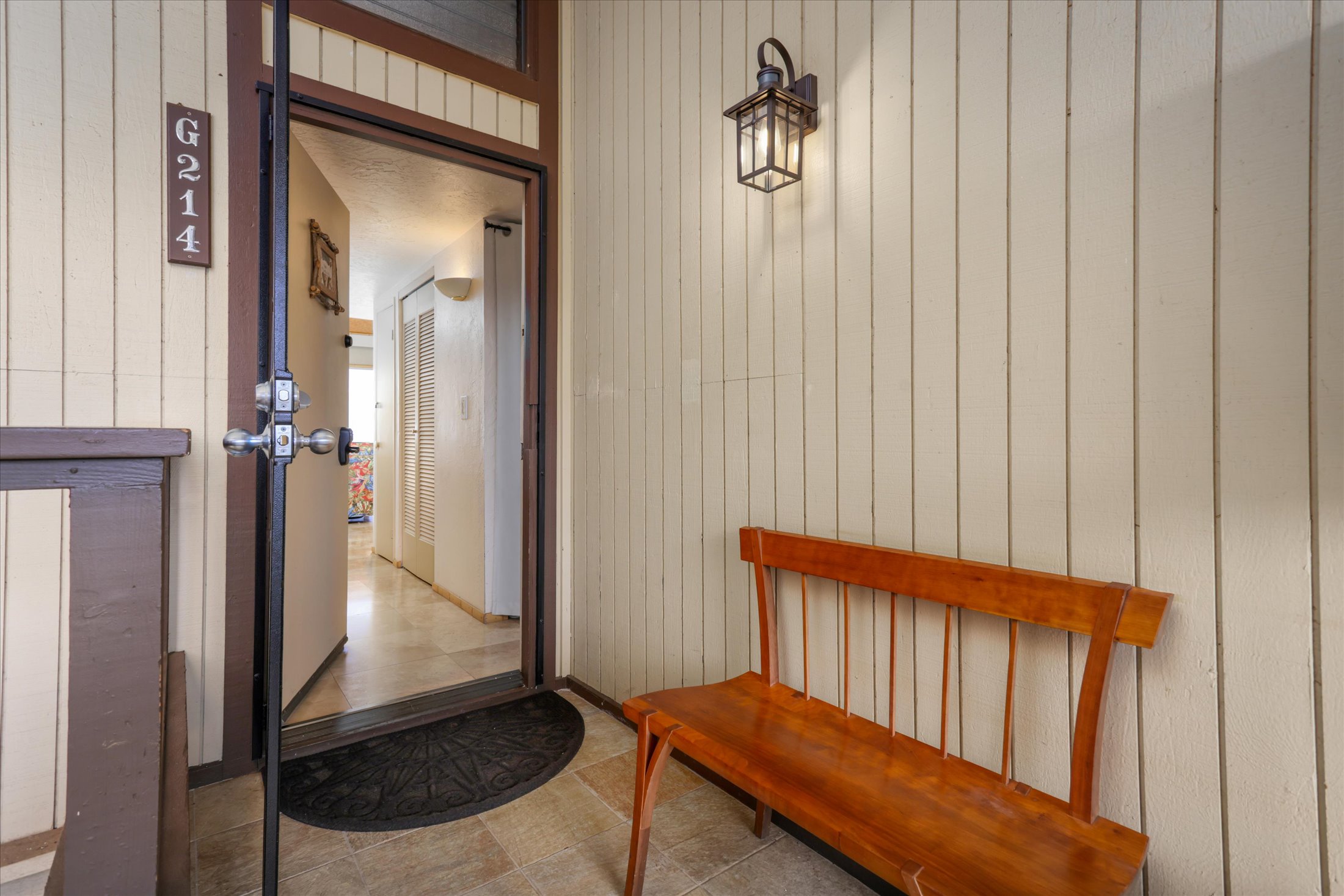 68-1771 Melia Street, Unit G214 Waikoloa, HI 96738 - Photo 6 of 29 a view of a hallway with a door and a mirror