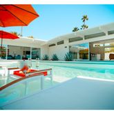 a view of a patio with a table and chairs under an umbrella