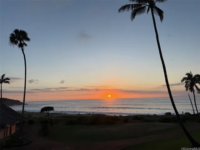 a kitchen with sink and view of living room