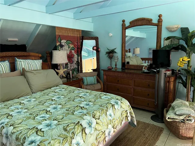 a bed room with a bed and a large window